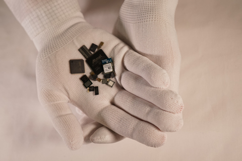 Generic components being held in gloved hands